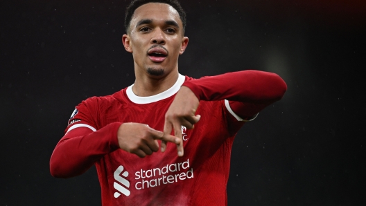 TOPSHOT - Liverpool's English defender #66 Trent Alexander-Arnold celebrates after scoring their fourth goal during the English Premier League football match between Liverpool and Fulham at Anfield in Liverpool, northwest England, on December 3, 2023. (Photo by Paul ELLIS / AFP) / RESTRICTED TO EDITORIAL USE. No use with unauthorized audio, video, data, fixture lists, club/league logos or 'live' services. Online in-match use limited to 120 images. An additional 40 images may be used in extra time. No video emulation. Social media in-match use limited to 120 images. An additional 40 images may be used in extra time. No use in betting publications, games or single club/league/player publications. /