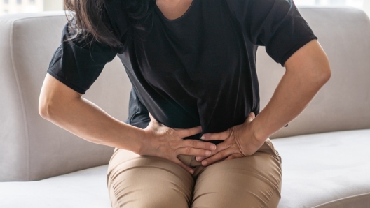 Abdominal pain in woman with stomachache illness from menstruation cramps, stomach cancer, irritable bowel syndrome, pelvic discomfort, Indigestion, Diarrhea or GERD (gastro-esophageal reflux disease)