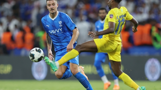 RIYADH, SAUDI ARABIA - AUGUST 12: Abdullah Al Khaibari of Al Nassr passes the ball whilst under pressure from Sergej Milinkovic-Savic of Al Hilal during the Arab Club Champions Cup Final between Al Hilal and Al Nassr at King Fahd International Stadium on August 12, 2023 in Riyadh, Saudi Arabia. (Photo by Yasser Bakhsh/Getty Images)