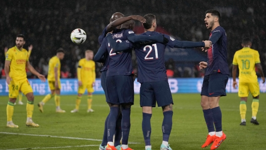 PSG's Randal Kolo Muani, center, celebrates with teammates after scoring his side's second goal during the French League One soccer match between Paris Saint-Germain and Nantes at the Parc des Princes in Paris, Saturday, Dec. 9, 2023. (AP Photo/Thibault Camus)