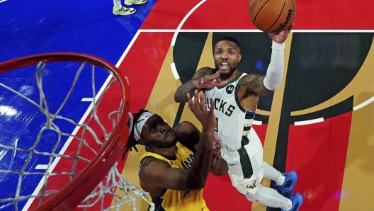 Milwaukee Bucks guard Damian Lillard, right, shoots the ball against Indiana Pacers center Myles Turner during a semifinal game in the NBA basketball In-Season Tournament, Thursday, Dec. 7, 2023, in Las Vegas. (Kyle Terada/Pool Photo via AP)