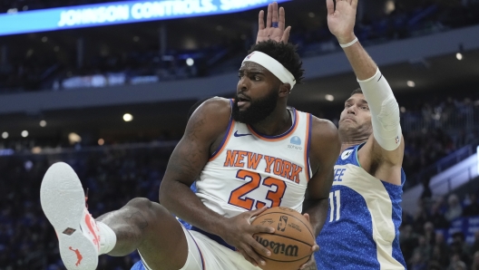 New York Knicks' Mitchell Robinson rebounds in front of Milwaukee Bucks' Brook Lopez during the first half of an NBA basketball game Friday, Nov. 3, 2023, in Milwaukee. (AP Photo/Morry Gash)