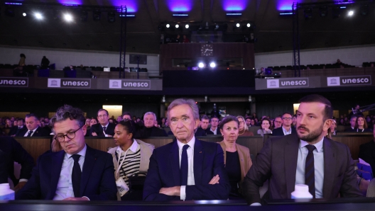 World's top luxury group LVMH head Bernard Arnault (C) looks on as he attends the presentation of the second part of the group's sustainability plan, called Life 360, next to French Minister for Ecological Transition and Territories' Cohesion Christophe Bechu (L) and European Commissioner for the Environment, Oceans and Fisheries in the European Commission Virginijus Sinkevicius (R) at the Maison de L'Unesco in Paris, on December 14, 2023. (Photo by Emmanuel Dunand / AFP)