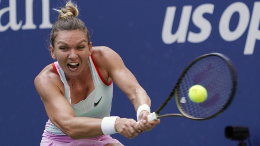 FILE - Simona Halep, of Romania, returns a shot to Daria Snigur, of Ukraine, during the first round of the U.S. Open tennis championships Aug. 29, 2022, in New York. Two-time Grand Slam champion Simona Halep has asked the Court of Arbitration for Sport to overturn the four-year ban she received for doping violations. The court said Tuesday, Oct. 24, 20234 it has registered Halep's appeal of the International Tennis Integrity Agency's decision in September. (AP Photo/Seth Wenig, File)