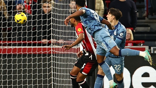 Aston Villa's English striker #11 Ollie Watkins (C) heads home their second goal during the English Premier League football match between Brentford and Aston Villa at Gtech Community Stadium in London on December 17, 2023. (Photo by HENRY NICHOLLS / AFP) / RESTRICTED TO EDITORIAL USE. No use with unauthorized audio, video, data, fixture lists, club/league logos or 'live' services. Online in-match use limited to 120 images. An additional 40 images may be used in extra time. No video emulation. Social media in-match use limited to 120 images. An additional 40 images may be used in extra time. No use in betting publications, games or single club/league/player publications. /