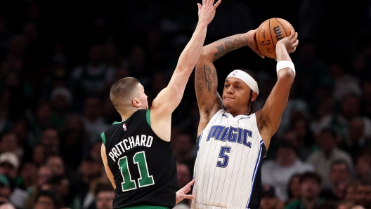 BOSTON, MASSACHUSETTS - DECEMBER 15: Paolo Banchero #5 of the Orlando Magic looks to pass around Payton Pritchard #11 of the Boston Celtics during the second half at TD Garden on December 15, 2023 in Boston, Massachusetts. The Celtics defeat the Magic 128-111. NOTE TO USER: User expressly acknowledges and agrees that, by downloading and or using this photograph, user is consenting to the terms and conditions of the Getty Images License Agreement.   Maddie Meyer/Getty Images/AFP (Photo by Maddie Meyer / GETTY IMAGES NORTH AMERICA / Getty Images via AFP)