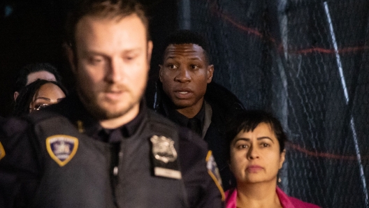 US actor Jonathan Majors (C) leaves a courtroom after being found guilty of assault and harassment of his former girlfriend, at the Manhattan criminal courts in New York City on December 18, 2023. A New York jury on December 18, 2023 found actor Jonathan Majors guilty of assault and harassment of his former girlfriend during a domestic dispute. Majors, a rising star who has appeared in Disneys Marvel franchise and "Creed III," was convicted on Monday of one count of reckless assault in the 3rd degree and a non-criminal charge of harassment as a violation. (Photo by Yuki IWAMURA / AFP)