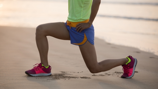 Healthy lifestyle young fitness woman exercise on beach