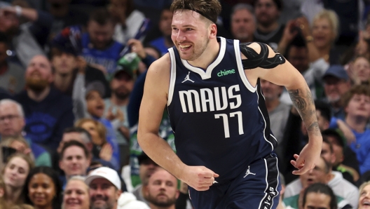 Dallas Mavericks guard Luka Doncic smiles as he runs back up the court after an assist against the San Antonio Spurs during the second half of an NBA basketball game Saturday, Dec. 23, 2023, in Dallas. (AP Photo/Richard W. Rodriguez)