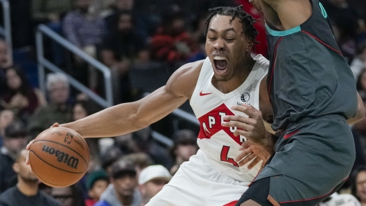 Toronto Raptors forward Scottie Barnes, left, drives against Washington Wizards guard Bilal Coulibaly during the first half of an NBA basketball game Wednesday, Dec. 27, 2023, in Washington. (AP Photo/Alex Brandon)