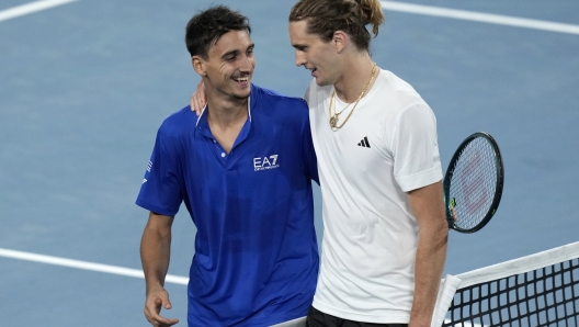 Italy's Lorenzo Sonego, left, and Germany's Alexander Zverev meet at the net following Zverev's win in their match during the United Cup tennis tournament in Sydney, Saturday, Dec. 30, 2023. (AP Photo/Rick Rycroft)