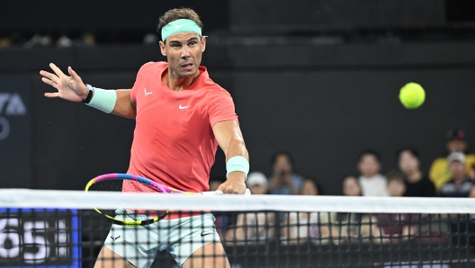 epa11050223 Rafael Nadal of Spain in action during his doubles match with partner Marc Lopez of Spain against Max Purcell and Jordan Thompson of Australia during their round of 32 doubles match on Day 1 of the 2024 Brisbane International at the Queensland Tennis Centre in Brisbane, Australia, 31 December 2023.  EPA/DARREN ENGLAND  AUSTRALIA AND NEW ZEALAND OUT