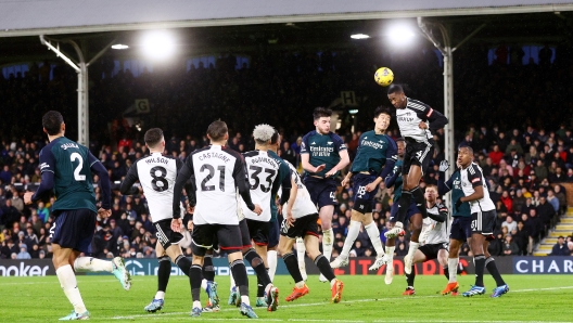 LONDON, ENGLAND - DECEMBER 31: Tosin Adarabioyo of Fulham wins a header whilst under pressure from Takehiro Tomiyasu of Arsenal during the Premier League match between Fulham FC and Arsenal FC at Craven Cottage on December 31, 2023 in London, England. (Photo by Clive Rose/Getty Images)