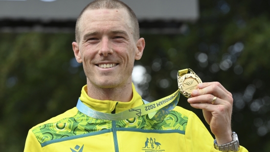 FILE - Gold medal winner Rohan Dennis of Australia poses with his medal after the men's cycling individual time trials at the Commonwealth Games in West Park, Wolverhampton, England, on Aug. 4, 2022. Dennis was reported to have been charged in connection with the death of his wife, Olympic cyclist Melissa Hoskins, who died after being struck by a vehicle while riding in Adelaide. (AP Photo/Rui Vieira, File)