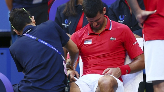 A trainer massages the right arm of Novak Djokovic of Serbia in a break in his match against Alex de Minaur of Australia during the United Cup tennis tournament in Perth, Australia, Wednesday, Jan. 3, 2024. (AP Photo/Trevor Collens)