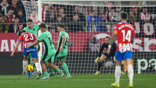 GIRONA, SPAIN - JANUARY 03: Ivan Martin of Girona FC scores their team's fourth goal under pressure from Marcos Llorente and Saul Niguez of Atletico Madrid during the LaLiga EA Sports match between Girona FC and Atletico Madrid at Montilivi Stadium on January 03, 2024 in Girona, Spain. (Photo by Alex Caparros/Getty Images)