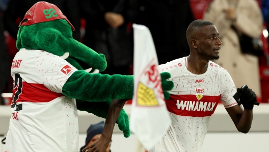 TUTTGART, GERMANY - DECEMBER 20: Sehrou Guirassy of VfB Stuttgart celebrates with mascot, Fritzle after scoring their team's second goal during the Bundesliga match between VfB Stuttgart and FC Augsburg at MHPArena on December 20, 2023 in Stuttgart, Germany. (Photo by Alexander Hassenstein/Getty Images)