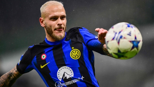 Inter Milan's Italian defender #32 Federico Dimarco eyes the ball during the UEFA Champions League 1st round day 6 Group D football match between Inter Milan and Real Sociedad at the San Siro stadium in Milan on December 12, 2023. (Photo by Marco BERTORELLO / AFP)