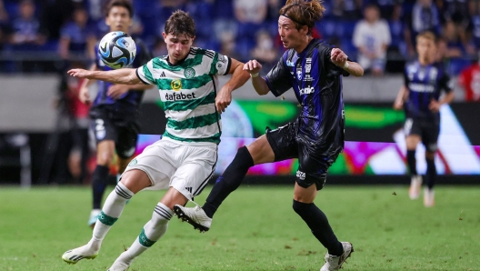 Celtic's midfielder Rocco Vata (L) and Gamba Osaka's defender Hiroki Fujiharu fight for the ball during a friendly football match between Japan's Gamba Osaka and Scotland's Celtic at Suita City Stadium in the city of Suita, Osaka prefecture on July 22, 2023. (Photo by PAUL MILLER / AFP)