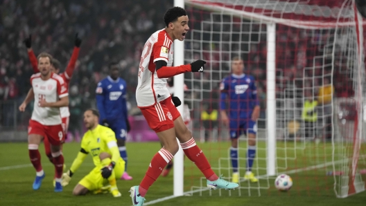 Bayern's Jamal Musiala celebrates after scoring the opening goal during the German Bundesliga soccer match between FC Bayern Munich and TSG 1899 Hoffenheim at the Allianz Arena in Munich, Germany, Friday, Jan. 12, 2024. (AP Photo/Matthias Schrader)