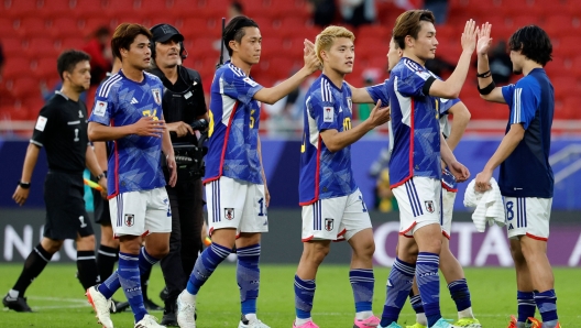 Japan's players greet each other at the end of the Qatar 2023 AFC Asian Cup Group D football match between Japan and Vietnam at the Al-Thumama Stadium in Doha on January 14, 2024. (Photo by KARIM JAAFAR / AFP)