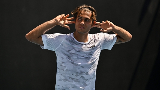 Italy's Flavio Cobolli celebrates after victory against Chile's Nicolas Jarry during their men's singles match on day two of the Australian Open tennis tournament in Melbourne on January 15, 2024. (Photo by Lillian SUWANRUMPHA / AFP) / -- IMAGE RESTRICTED TO EDITORIAL USE - STRICTLY NO COMMERCIAL USE --