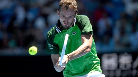 epa11078396 Daniil Medvedev of Russia returns during his first round match against Terence Atmane of France on Day 2 of the 2024 Australian Open at Melbourne Park in Melbourne, Australia, 15 January 2024.  EPA/LUKAS COCH AUSTRALIA AND NEW ZEALAND OUT