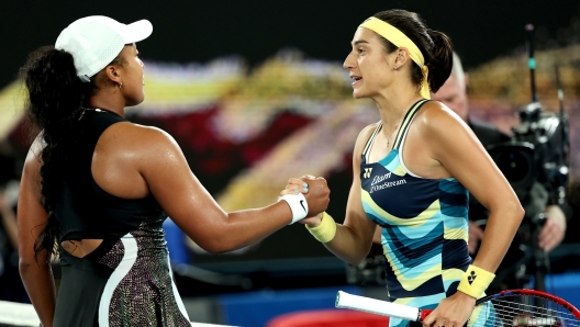 MELBOURNE, AUSTRALIA - JANUARY 15: Caroline Garcia of France embraces Naomi Osaka of Japan after winning in their round one singles match during the 2024 Australian Open at Melbourne Park on January 15, 2024 in Melbourne, Australia. (Photo by Cameron Spencer/Getty Images)