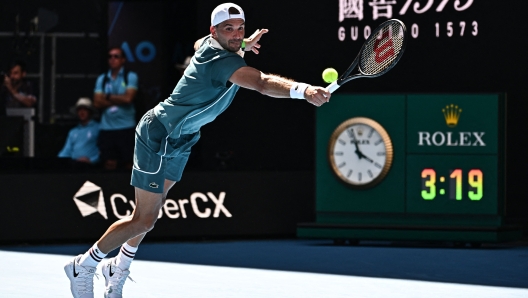 Bulgaria's Grigor Dimitrov hits a return against Hungary's Marton Fucsovics during their men's singles match on day three of the Australian Open tennis tournament in Melbourne on January 16, 2024. (Photo by Lillian SUWANRUMPHA / AFP) / -- IMAGE RESTRICTED TO EDITORIAL USE - STRICTLY NO COMMERCIAL USE --