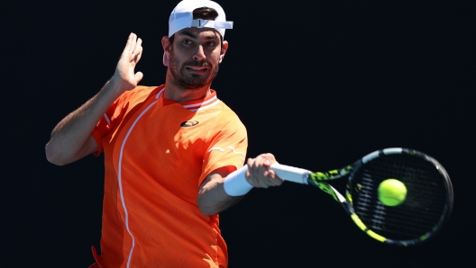 MELBOURNE, AUSTRALIA - JANUARY 16: Giulio Zeppieri of Italy plays a forehand in their round one singles match against Dusan Lajovic of Serbia during the 2024 Australian Open at Melbourne Park on January 16, 2024 in Melbourne, Australia. (Photo by Cameron Spencer/Getty Images)