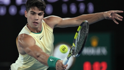 Carlos Alcaraz of Spain plays a backhand return to Richard Gasquet of France during their first round match at the Australian Open tennis championships at Melbourne Park, Melbourne, Australia, Tuesday, Jan. 16, 2024. (AP Photo/Andy Wong)