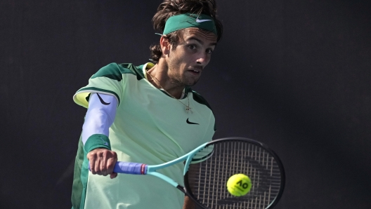 Lorenzo Musetti of Italy plays a backhand return to Luca Van Assche of France during their second round match at the Australian Open tennis championships at Melbourne Park, Melbourne, Australia, Wednesday, Jan. 17, 2024. (AP Photo/Alessandra Tarantino)