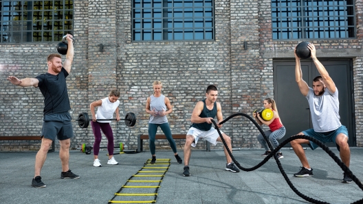 Group of healthy people working out, outside workout