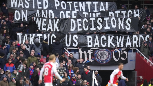 Crystal Palace fans hold a banner on the stands during the English Premier League soccer match between Arsenal and Crystal Palace at Emirates Stadium in London, Saturday, Jan. 20, 2024. (AP Photo/Kirsty Wigglesworth)