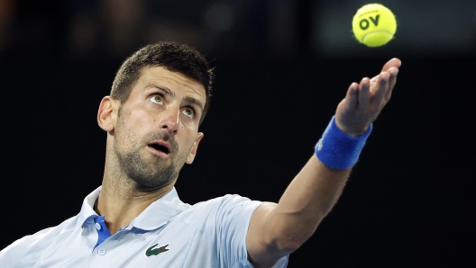 epa11093280 Novak Djokovic of Serbia serves to Adrian Mannarino of France during the Men's 4th round match at the Australian Open tennis tournament in Melbourne, Australia, 21 January 2024.  EPA/MAST IRHAM