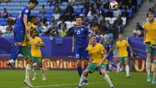 Uzbekistan's Azizbek Turgunboev heads to score the first goal during the Asian Cup Group B soccer match between Australia and Uzbekistan at Al Janoub Stadium in Doha, Qatar, Tuesday, Jan. 23, 2024. (AP Photo/Thanassis Stavrakis)