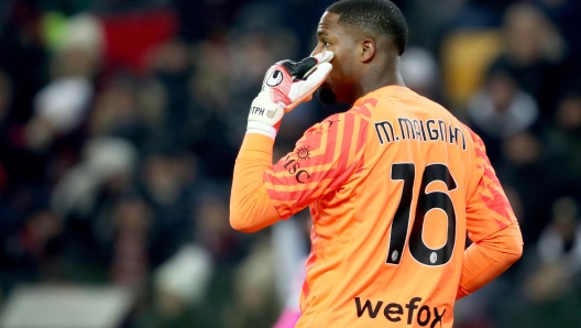 Milans Mike Maignan in action during the Italian Serie A soccer match Udinese Calcio vs AC Milan at the Friuli - Dacia Arena stadium in Udine, Italy, 20 January 2024. ANSA / GABRIELE MENIS