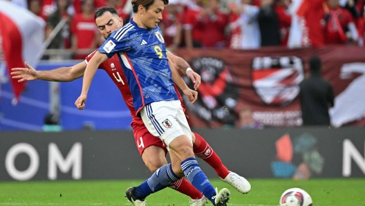 Indonesia's defender #04 Jordi Amat vies for the ball against Japan's forward #09 Ayase Ueda during the Qatar 2023 AFC Asian Cup Group D football match between Japan and Indonesia at al-Thumama Stadium in Doha on January 24, 2024. (Photo by HECTOR RETAMAL / AFP)