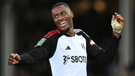 Fulham's English defender  #04 Tosin Adarabioyo celebrates scoring the winning goal in a penalty shoot-out in the English League Cup quarter-final football match between Everton and Fulham at Goodison Park in Liverpool, north west England on December 19, 2023. (Photo by Paul ELLIS / AFP) / RESTRICTED TO EDITORIAL USE. No use with unauthorized audio, video, data, fixture lists, club/league logos or 'live' services. Online in-match use limited to 120 images. An additional 40 images may be used in extra time. No video emulation. Social media in-match use limited to 120 images. An additional 40 images may be used in extra time. No use in betting publications, games or single club/league/player publications. /