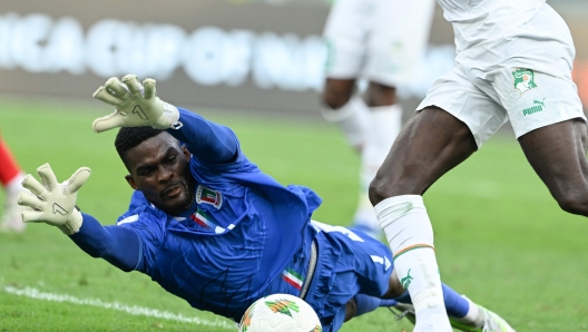 Equatorial Guinea's goalkeeper #1 Jesus Owono makes a save during the Africa Cup of Nations (CAN) 2024 group A football match between Equatorial Guinea and Ivory Coast at the Alassane Ouattara Olympic Stadium in Ebimpe, Abidjan on January 22, 2024. (Photo by Issouf SANOGO / AFP)