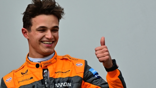 McLaren's British driver Lando Norris celebrates winning third place as he stands on the podium after the Emilia Romagna Formula One Grand Prix at the Autodromo Internazionale Enzo e Dino Ferrari race track in Imola, Italy, on April 24, 2022. (Photo by ANDREJ ISAKOVIC / AFP)