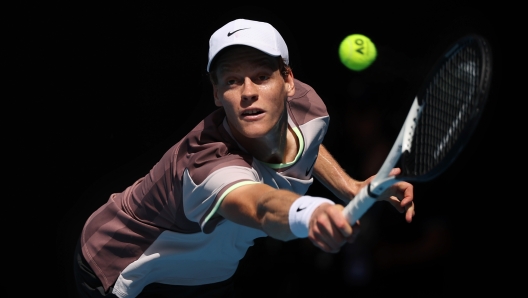 MELBOURNE, AUSTRALIA - JANUARY 26: Jannik Sinner of Italy plays a backhand in their Semifinal singles match against Novak Djokovic of Serbia during the 2024 Australian Open at Melbourne Park on January 26, 2024 in Melbourne, Australia. (Photo by Daniel Pockett/Getty Images)