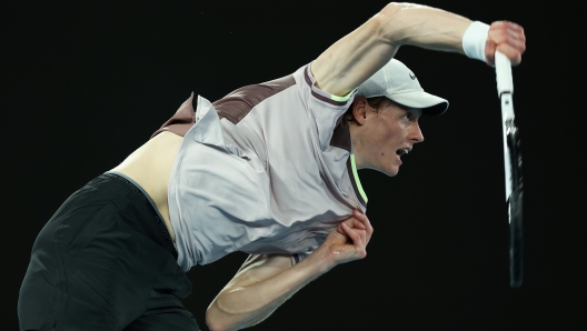 MELBOURNE, AUSTRALIA - JANUARY 28: Jannik Sinner of Italy serves in their Semifinal singles match against Novak Djokovic of Serbia during the 2024 Australian Open at Melbourne Park on January 26, 2024 in Melbourne, Australia. (Photo by Daniel Pockett/Getty Images)