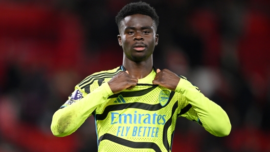 NOTTINGHAM, ENGLAND - JANUARY 30: Bukayo Saka of Arsenal prepares to gift a fan his shirt after the team's victory in the Premier League match between Nottingham Forest and Arsenal FC at City Ground on January 30, 2024 in Nottingham, England. (Photo by Michael Regan/Getty Images)