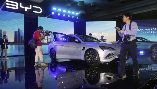 epa11086527 Journalists stand around a Build Your Dreams (BYD) Seal model during a launching ceremony of New Energy Vehicles (NEV) in Jakarta, Indonesia, 18 January 2024. BYD launched three NEVs Models: the BYD Seal, BYD Atto 3 and BYD Dolphin.  EPA/BAGUS INDAHONO