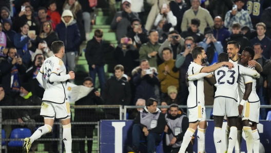 Real Madrid's Joselu celebrates with teammates after scoring his sides second goal during the Spanish La Liga soccer match between Getafe and Real Madrid at the Coliseum Alfonso Perez stadium in Getafe, Spain, Thursday, Feb. 1, 2024. (AP Photo/Manu Fernandez)