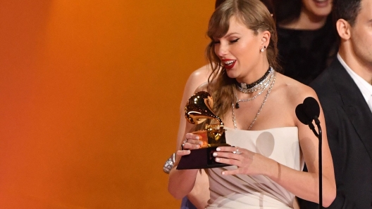 US singer-songwriter Taylor Swift accepts the Album Of The Year award for "Midnights" on stage during the 66th Annual Grammy Awards at the Crypto.com Arena in Los Angeles on February 4, 2024. (Photo by Valerie Macon / AFP)