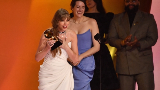 US singer-songwriter Taylor Swift accepts the Album Of The Year award for "Midnights" on stage during the 66th Annual Grammy Awards at the Crypto.com Arena in Los Angeles on February 4, 2024. (Photo by Valerie Macon / AFP)