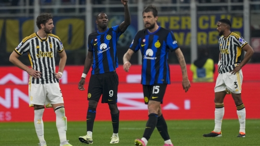 Inter Milan's Marcus Thuram, second from left, and Inter Milan's Francesco Acerbi celebrate after Juventus' Federico Gatti scored an own goal during a Serie A soccer match between Inter Milan and Juventus, in Milan, Italy, Sunday, Feb. 4, 2024. (AP Photo/Antonio Calanni)