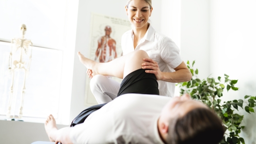 Modern rehabilitation physiotherapy woman worker with client